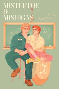 A blond young man sits on a stool while a redhead one sitting on a dreidel holds his face with one hand, with a blackboard at their backs. Cover of Mistletoe and Mishigas by M.A. Wardell